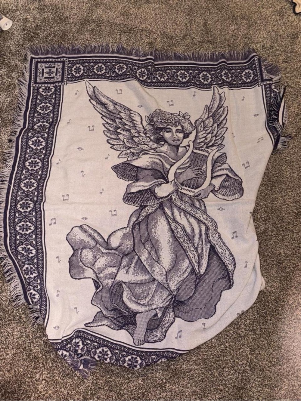 Purple and white tapestry blanket with music notes and angel playing harp